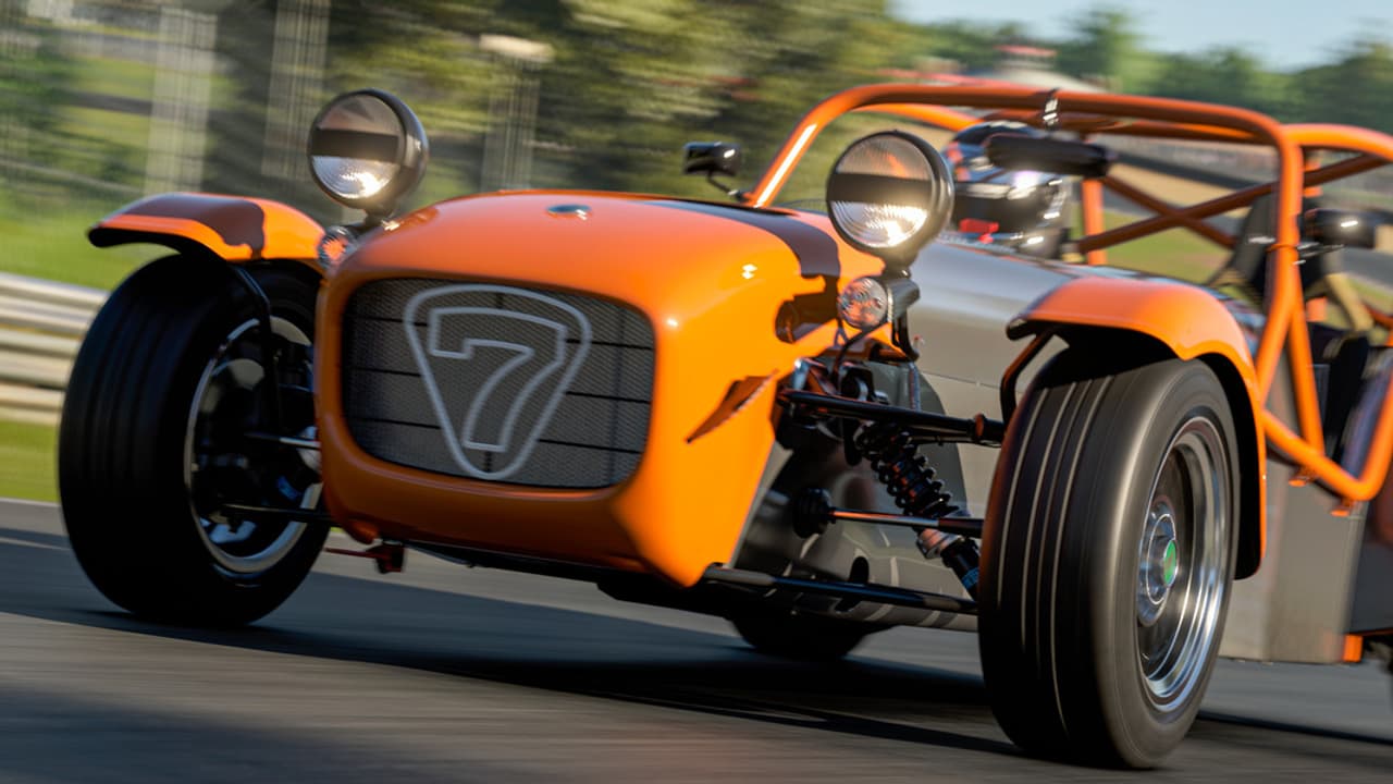 Un coche deportivo naranja en una pista de carreras.