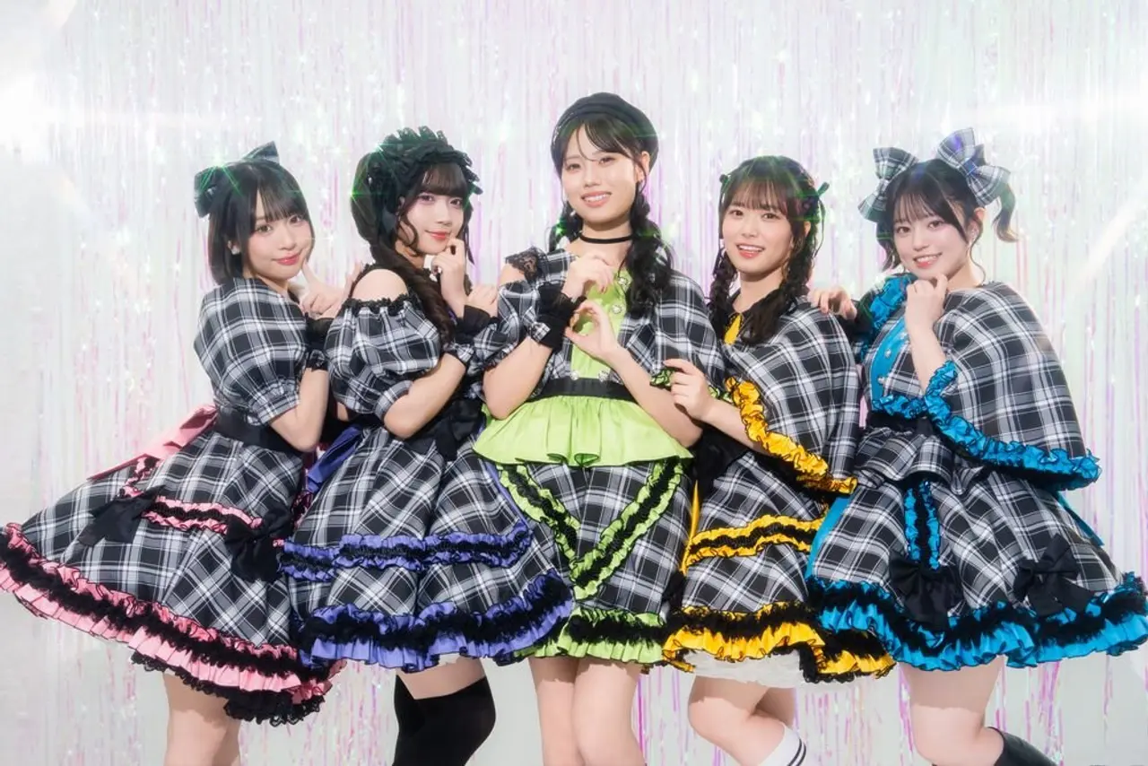 The five members of Maebashi Witches pose together in their lolita-style outfits.